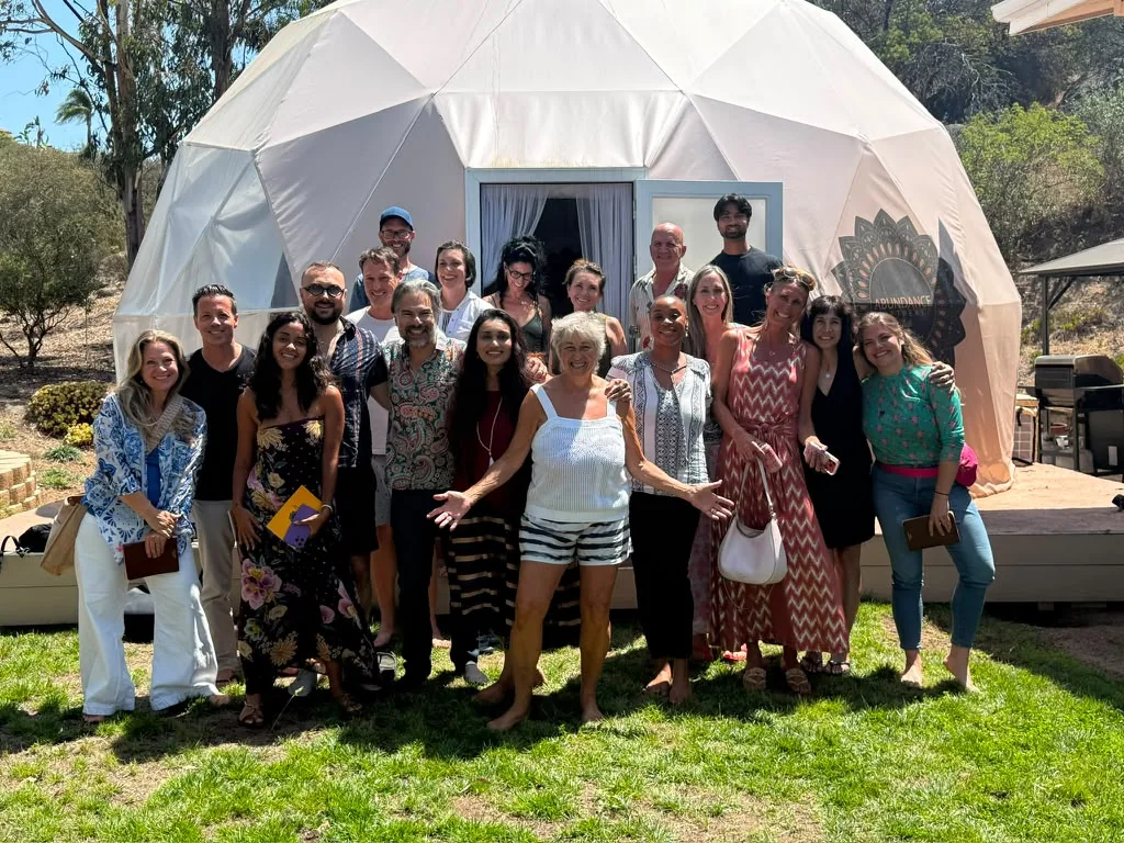 Retreat guests gathered together on the lawn in front of The Abundance Dome