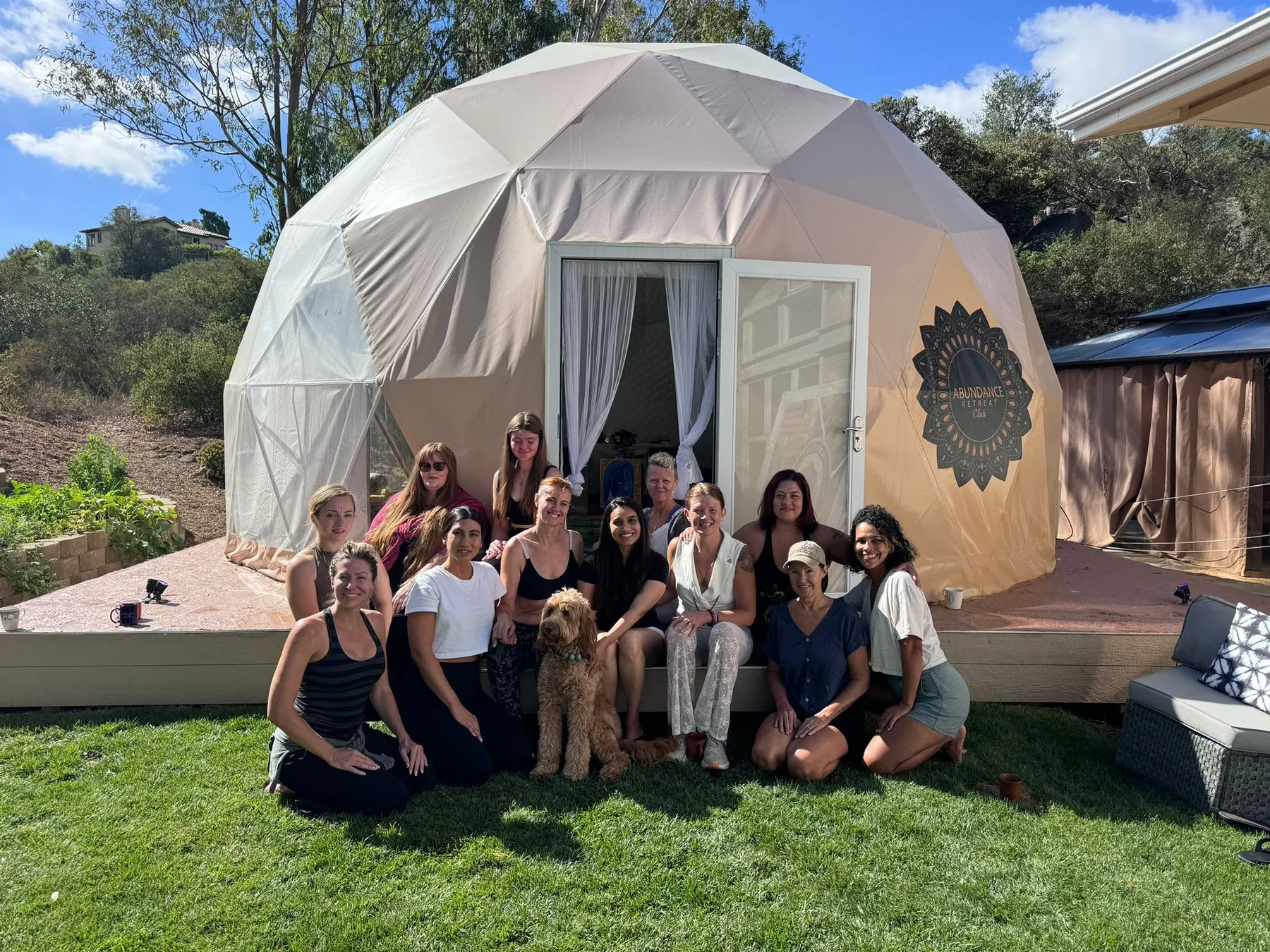 Retreat guests gathered with Sage in front of The Abundance Dome at The ARC